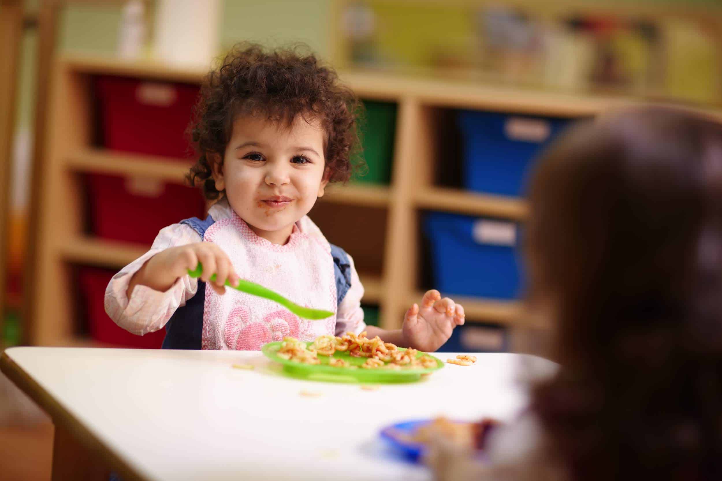 enfant mange à la garderie